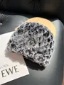 Detail of plush faux fur texture on a thick winter hat with leopard print pattern - Frost Black