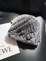 Detailed texture of grey rabbit fur knitted hat with thick stripes on a leather background - Dark Gray