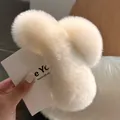 Detail view of large plush faux rabbit fur hair claw clip in soft creamy white color - Off White