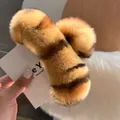 Detailed close-up of a large tiger-striped faux fur hair claw clip with soft plush texture - Leopard Print