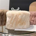 Detail of plush faux fur neck warmers in beige, brown and pink with soft fluffy texture - Apricot
