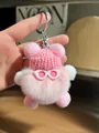 Close-up of pink fluffy plush keychain with a knitted hat and heart sunglasses charm - Light Pink