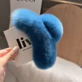 Macro shot of fluffy bright blue faux rabbit fur hair claw clip with plush texture - Blue