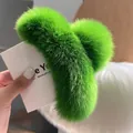 Close-up of a large fluffy neon green rabbit fur hair claw clip for thick hair - Dark Green