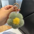 Close-up of a plush flower keychain with green fur petals and a gold metal ring clasp - Matcha Green