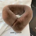 Close-up of fluffy faux rabbit fur scarf in brown on a marble surface with magazine - 60-80cm / Brown
