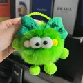Cute emerald green plush ball keychain with a dark green bow and bright yellow chain - Green
