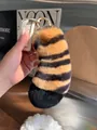 Detail of soft striped tiger tail plush keychain with gold ring in hand macro view - Large Tail