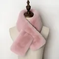 Detail of soft pink faux fur scarf with a crossed design on a beige display mannequin - Dusty Pink