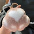 Plush heart-shaped keychain in dusty rose with white heart patterns and gold ring - Nude Pink