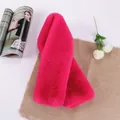 Close-up of fluffy faux rabbit fur scarf in vibrant magenta pink on a rustic linen background - Rose Red