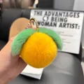 Close-up of yellow plush peach keychain with green leaves and golden metal ring clasp - Yellow (Round Buckle)