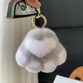 Gray and white rabbit fur paw keychain with golden ring on a BMW car key - Light Gray