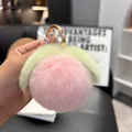 Close-up of soft pink faux fur peach keychain with green leaves and gold metal ring - Rose Pink (Round Buckle)