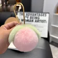 Close-up of a soft pink plush peach keychain with green leaves and a gold metal hook - Rose Pink (Water-drop Buckle)