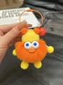 Orange plush monster keychain with yellow knit hat and a bright red metal bell - Orange Red