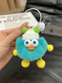 Blue fuzzy monster plush keychain with a white knit hat and orange beak accessory - Lake Blue