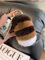 Close-up of fluffy striped rabbit fur keychain with gold ring on a car key - Round Buckle / Coffee Striped