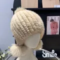 Detail of beige mink fur hat with fox fur pom poms and striped knitted texture for winter - One Size Stretchy / Beige