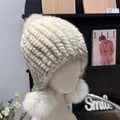 Detail of cream mink fur knitted hat featuring two large matching fluffy pom-poms - One Size Stretchy / Daylight White
