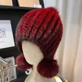 Detail view of burgundy faux fur knit hat with plush fox fur pompoms on both sides - One Size Stretchy / Burgundy