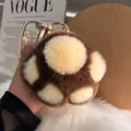 Brown and beige faux rabbit fur cat paw keychain with a gold ring on a car key - Round Buckle Style / Brown and White Patchwork