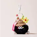 Detail of plush soot sprite keychain with brown knit hat and colorful beaded chain charm - Black