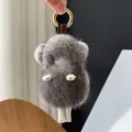 Detailed view of gray mink fur lamb keychain with white leather legs and gold ring - Dark Gray