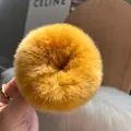 Detail of soft yellow rabbit fur scrunchie showing fluffy texture and premium material - Turmeric