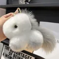 Close-up of fluffy faux rabbit fur unicorn keychain with gold metal ring detail - Light Gray (Round Clasp)