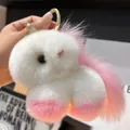 Close-up of white plush unicorn keychain with gold horn and pink gradient accents - Pale Pink (Round Clasp)