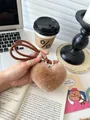 Detailed close-up of a brown fluffy heart keychain with a thick woven rope lanyard - Maillard Brown