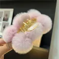 Close-up of pink faux rabbit fur plush hair claw clip with soft pompom texture - Light Purple