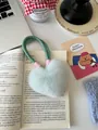 Close-up of fluffy mint green heart-shaped plush keychain on a woven cord handle - Mint Green