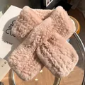 Close-up of soft pink rabbit fur scarf featuring a crossover design on a glass surface - Nude Pink
