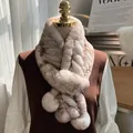 Close-up of thick real rex rabbit fur scarf with decorative pom-poms on a mannequin - Frost Yellow