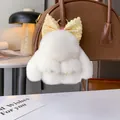 Portachiavi con coniglio di peluche bianco e fiocco glitterato dorato su borsa in pelle - Bianco Sporco