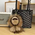 Cute brown plush lion keychain charm hanging on a luxury black designer tote bag - Natural Brown