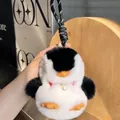 Plush penguin keychain in black and white rabbit fur with woven strap and pearl detail - Black