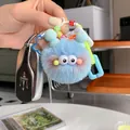 Detailed macro view of a blue faux mink fur monster keychain with colorful letter beads - Fresh Blue