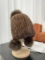 Brown mink fur knit hat for women featuring three decorative pom-poms and ear protection - Brown