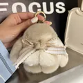 Plush beige bunny keychain with striped bow and gold ring for bags or keys - Khaki