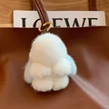 Cute white and blue mink fur bunny charm with golden clasp on a leather bag - Lake Blue Ears Leather Paws