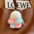 Multicolor mink fur bunny bag charm with golden clasp on a leather handbag - Multicolor Leather Paws
