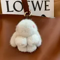 White mink fur bunny charm with pink ears and gold ring attached to a leather bag - Light Gray Leather Paws