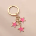 Schlüsselanhänger mit rosa Sternen, goldenem Metallring und drei Sternanhängern - Rosa