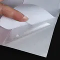 Transparent self-adhesive PVC cat scratch protector being peeled from white backing - Double Sided 30.5*43cm