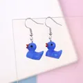 Detail shot of cute blue resin duck drop earrings with silver hooks on acrylic stand - Dark Blue