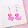 Close-up of creative pink resin duck earrings with silver hooks for women and girls - Rose Red