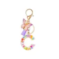 Resin letter C keychain with purple butterfly and glitter floral sequins in gold finish - Letter C